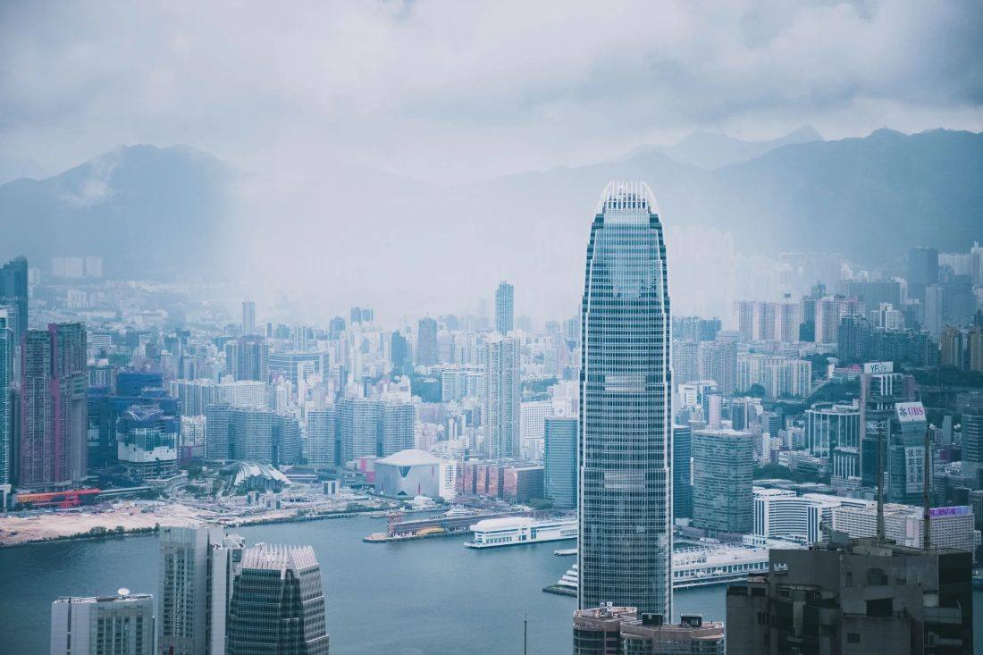 Hong Kong skyline and harbour against misty mountains