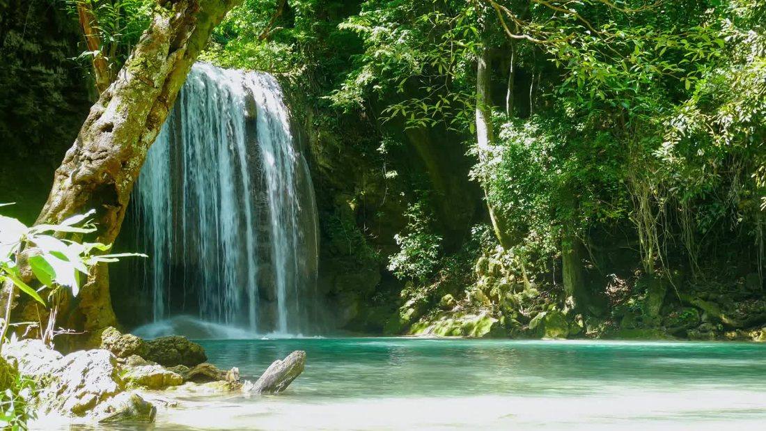 Erawan waterfall flowing through tropical forest